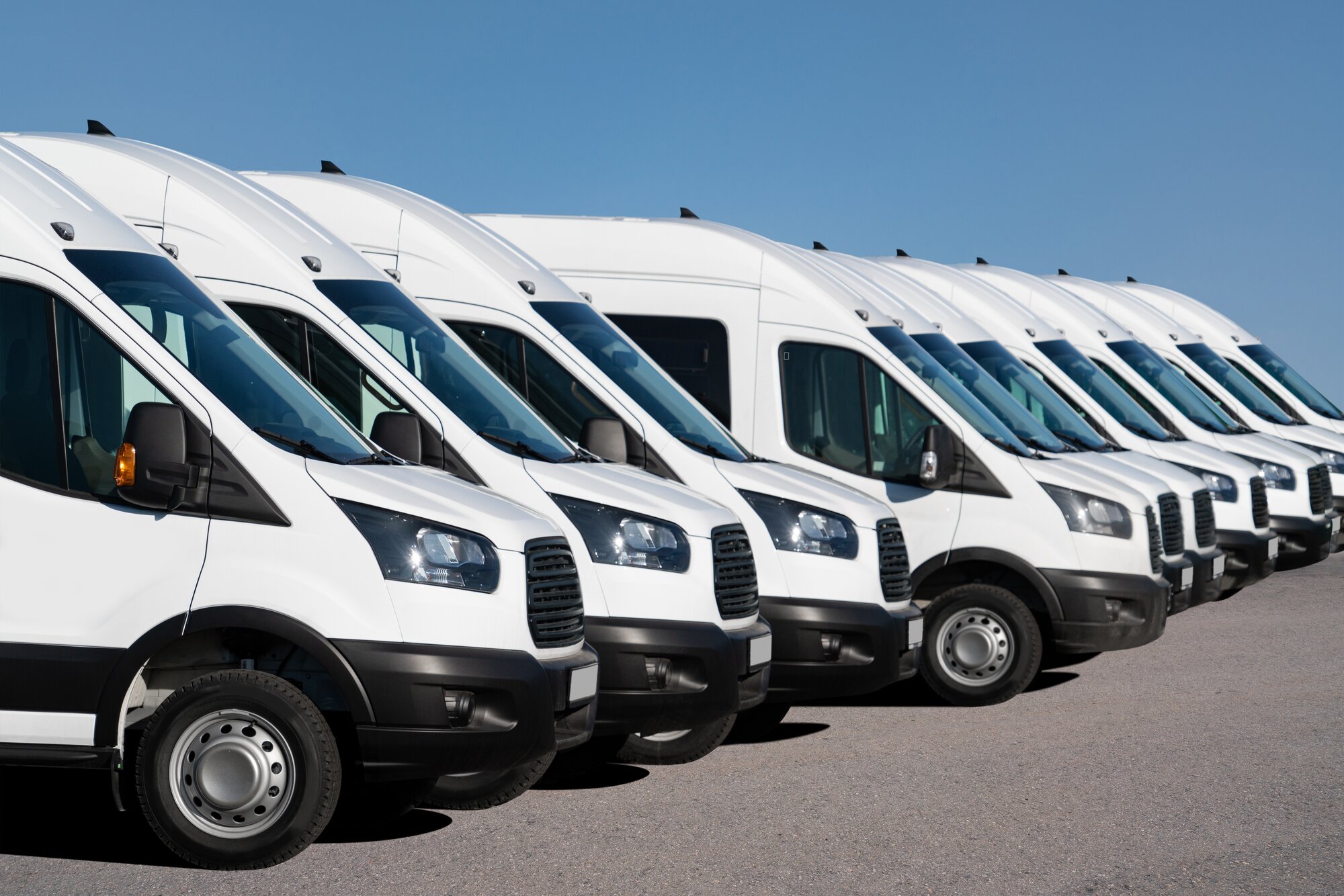 Fleet of white service vans lined up for mobile fleet locksmith service